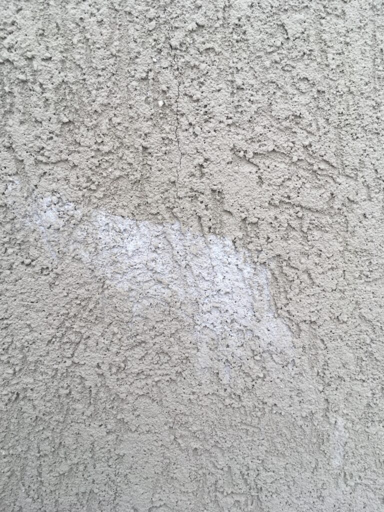 This photo shows efflorescense that has leached out of the stucco through a crack. The rain water went into the crack rec