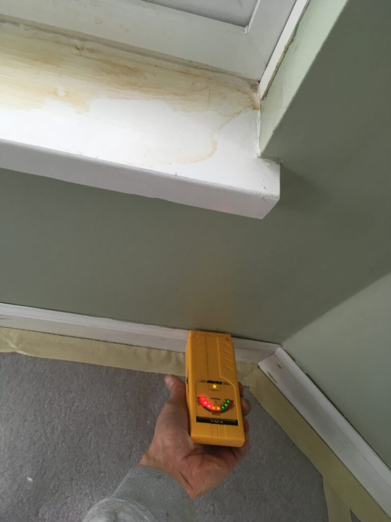 This wall has had rain water leak from the outside. The moisture meter indicates that it is still wet in the drywall.